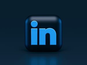 A 3D LinkedIn logo icon with a glossy black background and light blue letters, set against a dark blue gradient background—perfect for showcasing digital marketing or social media management expertise.
