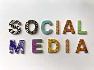 Colorful, patterned letters arranged on a white background spell out SOCIAL MEDIA, embodying the creativity and diversity essential for effective Social Media Management. Each letter features a unique design and vibrant color scheme.