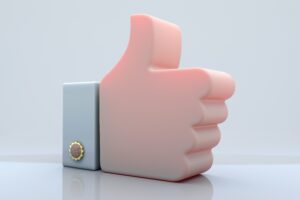 A 3D illustration of a large pink thumbs-up hand gesture, with a blue cuff and gold button, set against a plain light background—perfect for showcasing Social Media Management or marketing agency success.